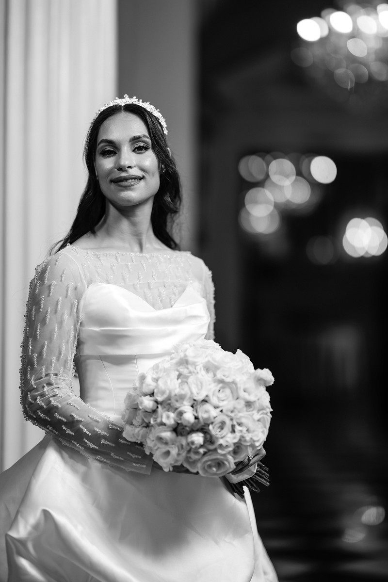 Black-and-white wedding portrait of a smiling bride holding a at The Mansion At Glen Cove, photographed by CJ Studios