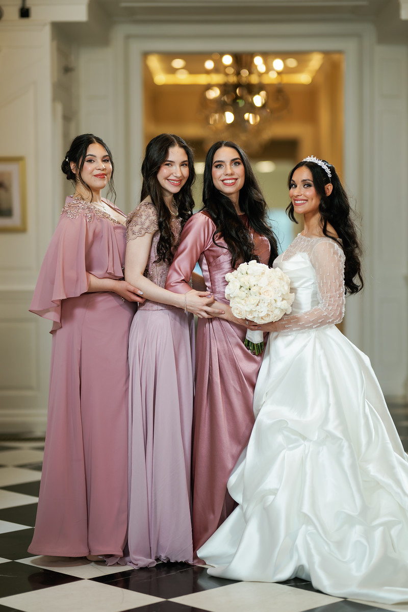 A group of four women pose for a formal portrait in a ballroom at The Mansion At Glen Cove, photographed by CJ Studios