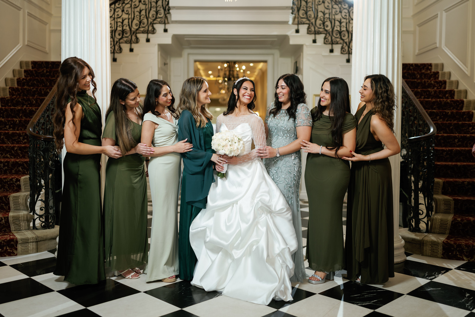 Bride in a white gown and lace headpiece stands centered on a at The Mansion At Glen Cove, photographed by CJ Studios