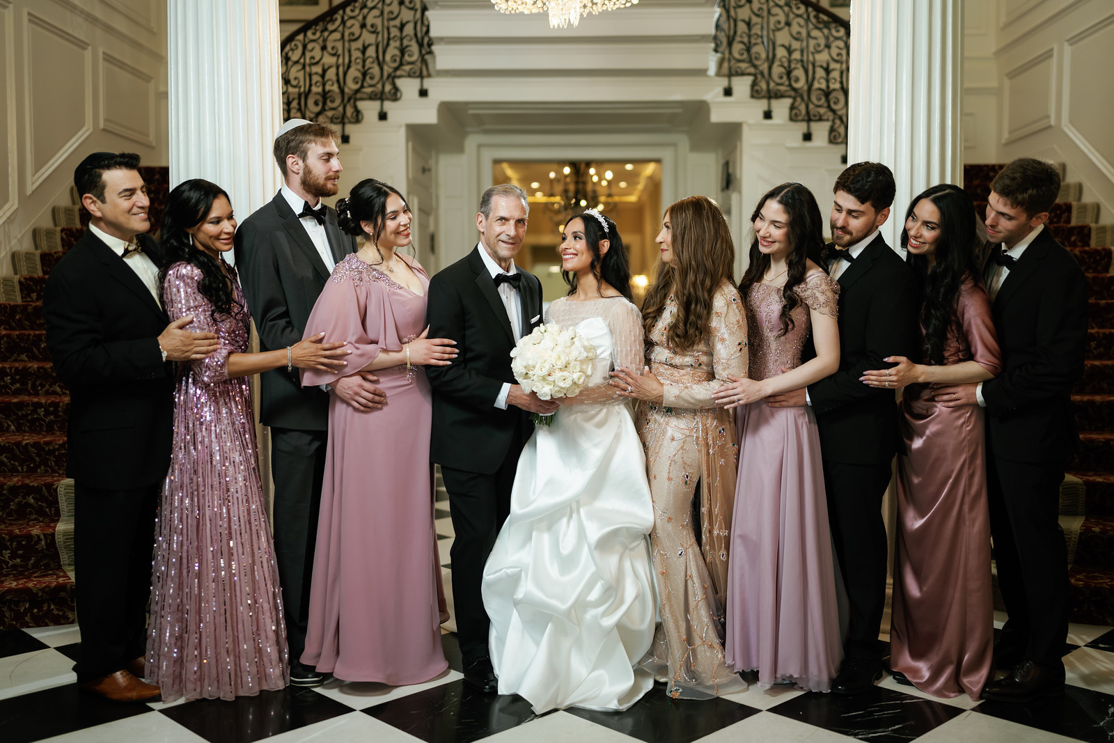 Bride in a white gown and groom in a black tuxedo stand together at at The Mansion At Glen Cove, photographed by CJ Studios