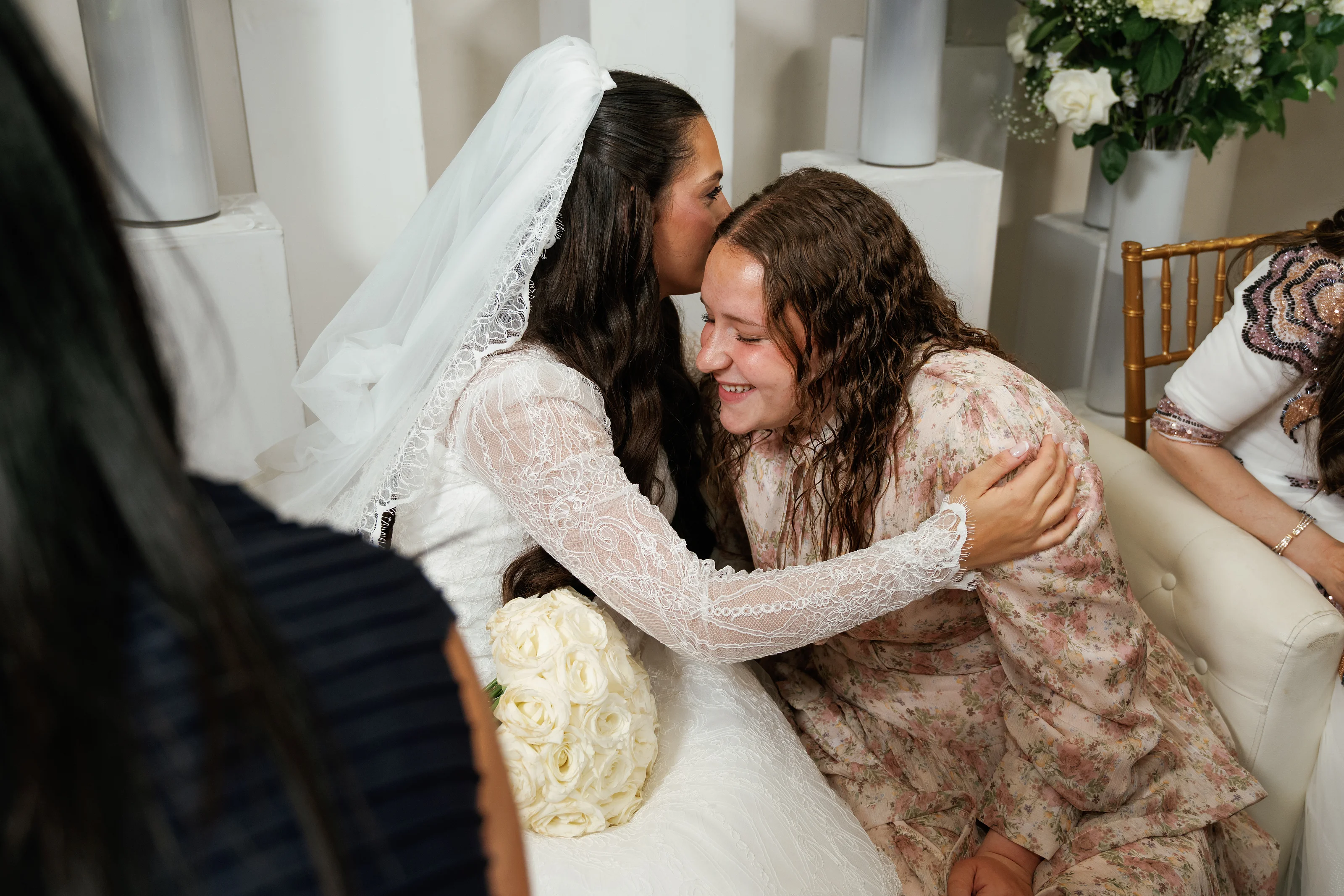 Bride in veil hugging a close family member with joyful tears at Falkirk Estate Country Club, photographed by CJ Studios