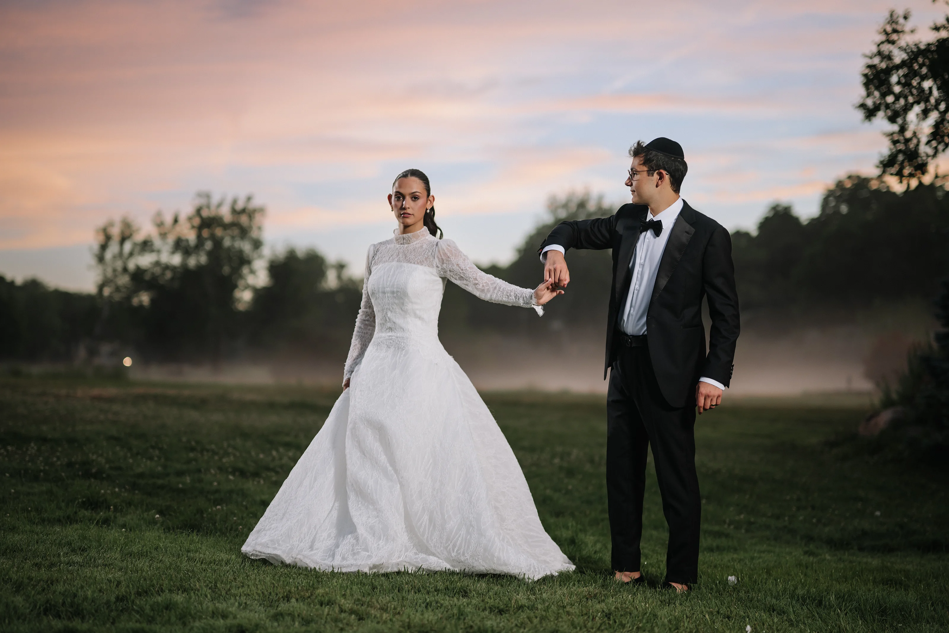 Outdoor sunset portrait of a bride and groom holding hands as at Falkirk Estate Country Club, photographed by CJ Studios