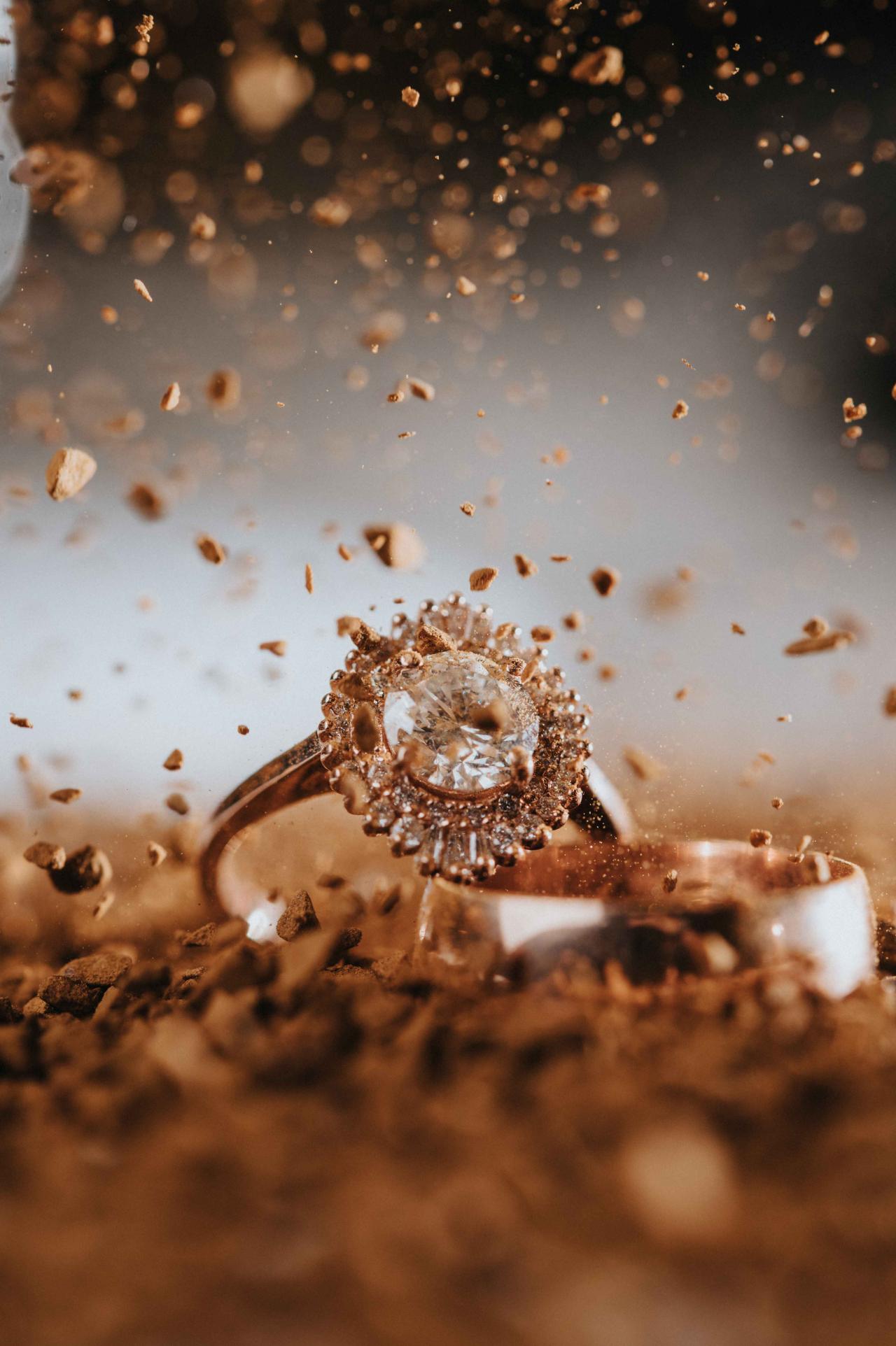 Close-up of a diamond ring surrounded by flying confetti during a wedding celebration.
