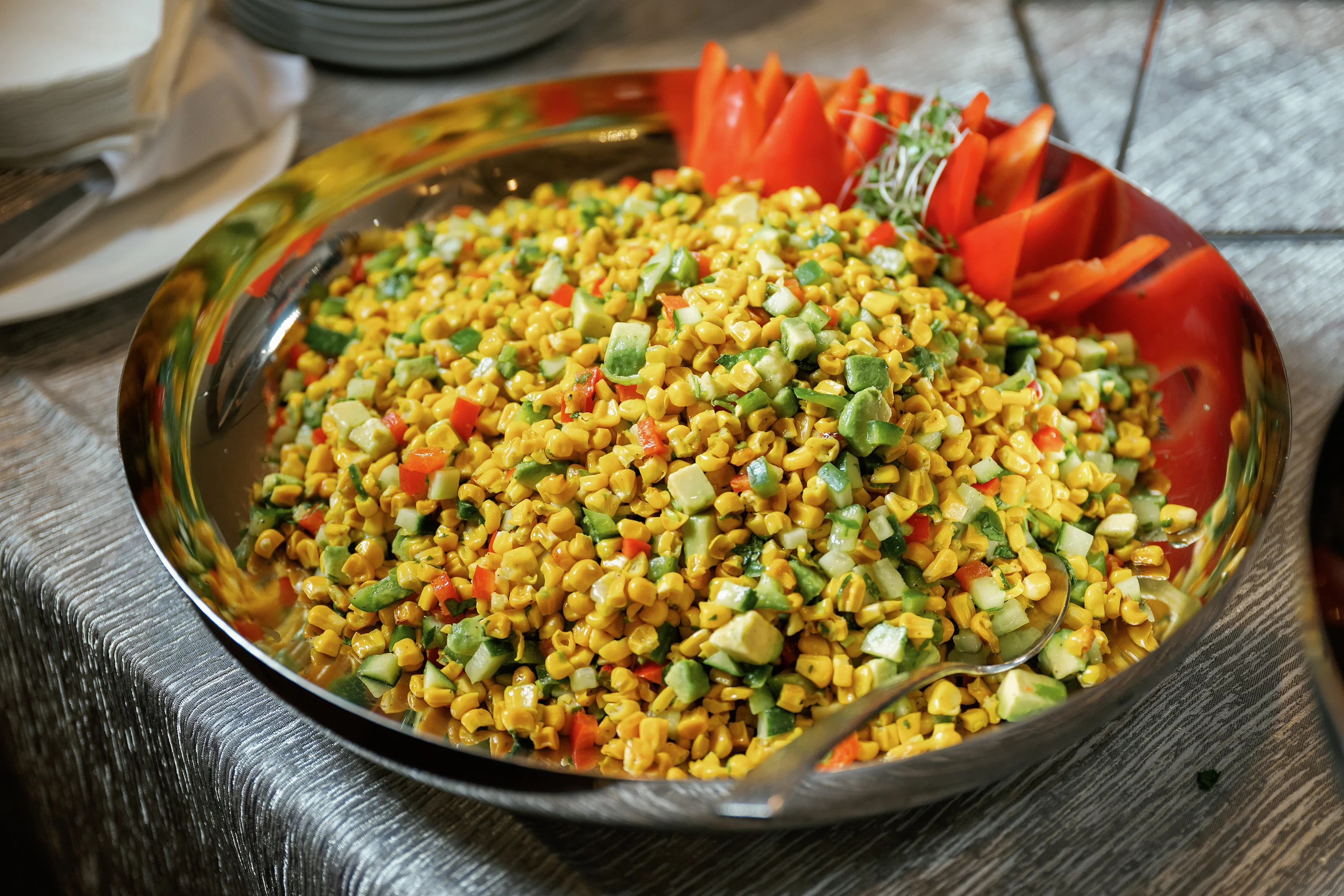Colorful corn and chopped vegetable salad on a catering buffet