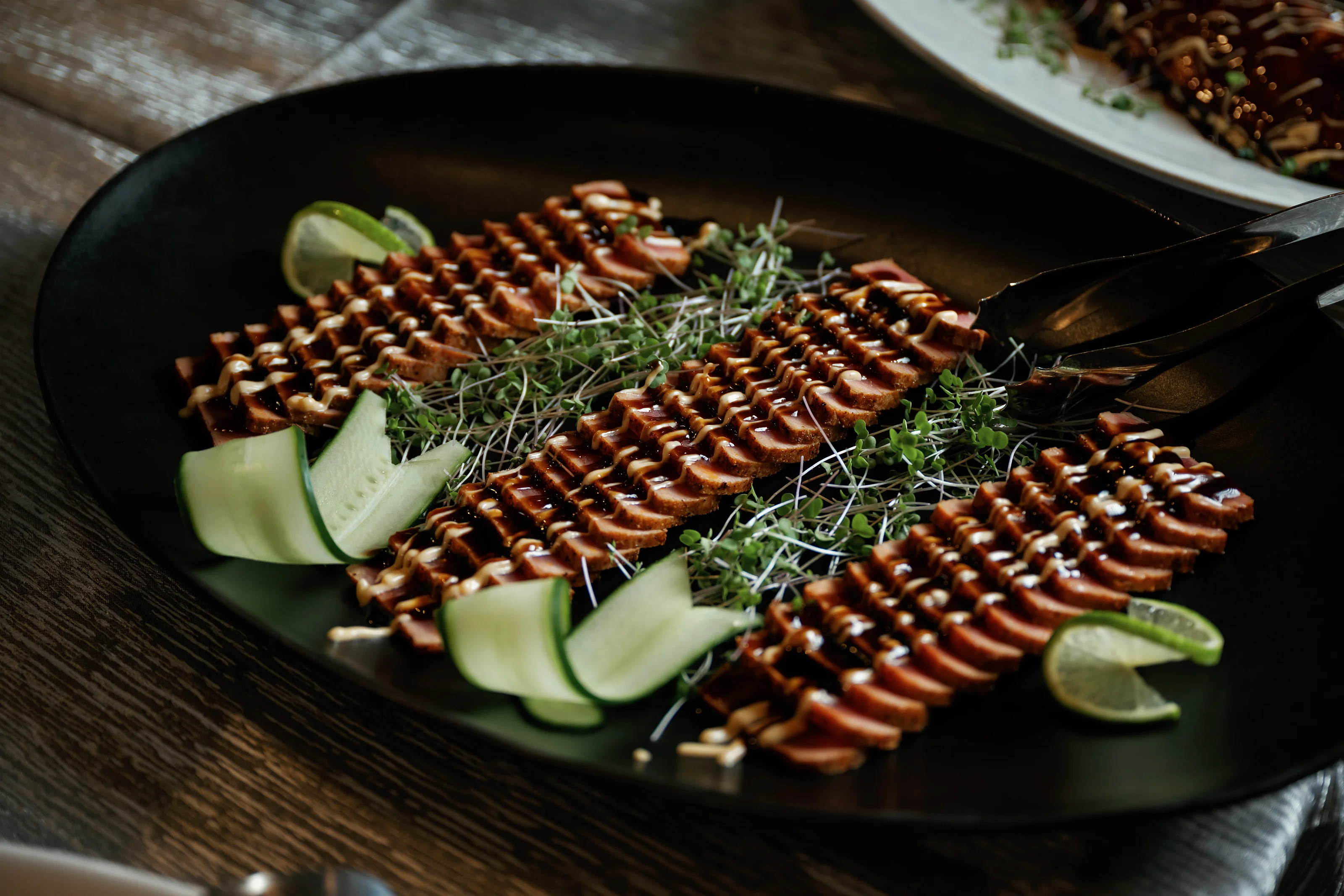 Glazed fish platter with sliced cucumber garnish
