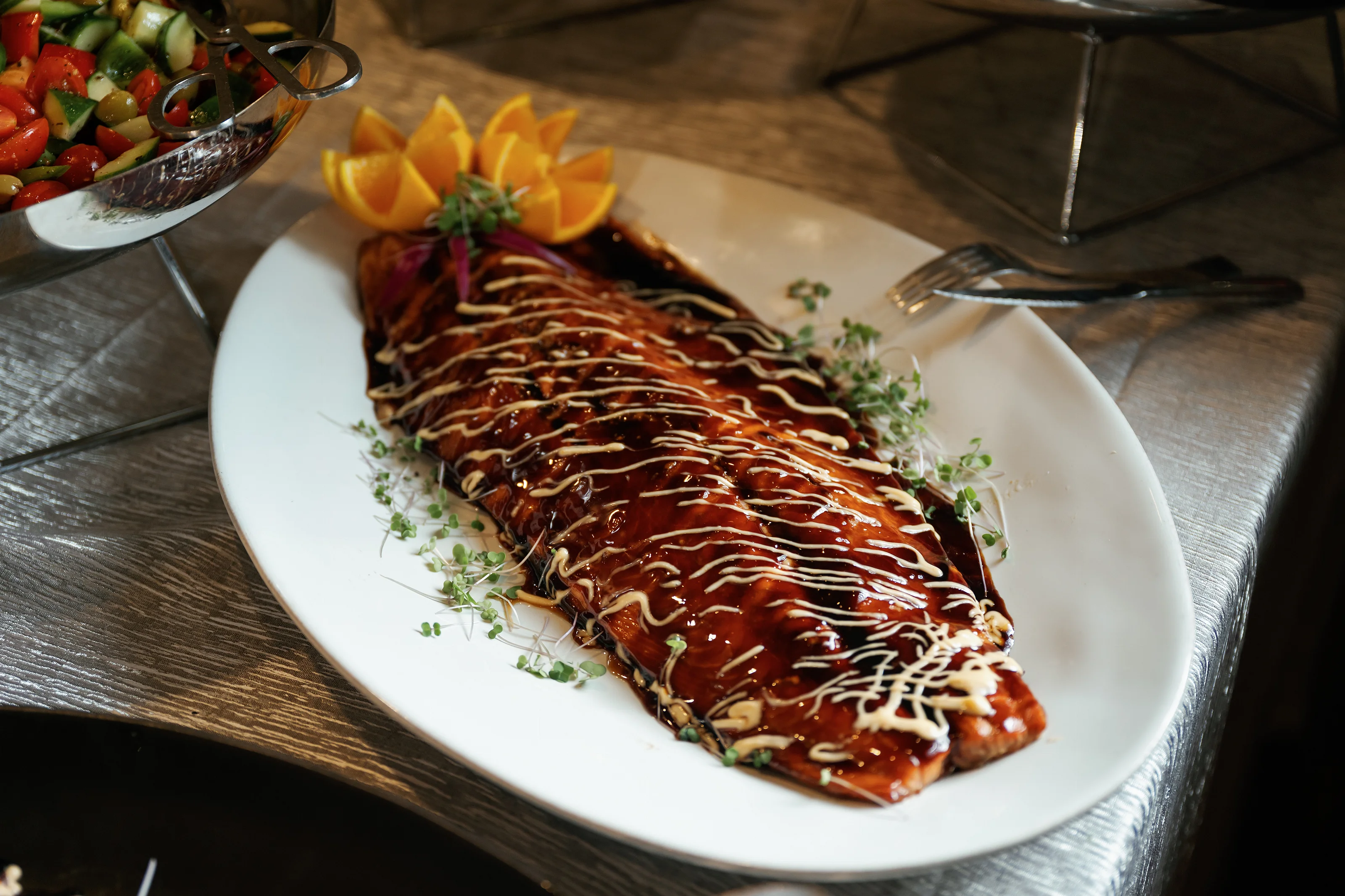 Glazed salmon fillet with citrus garnish