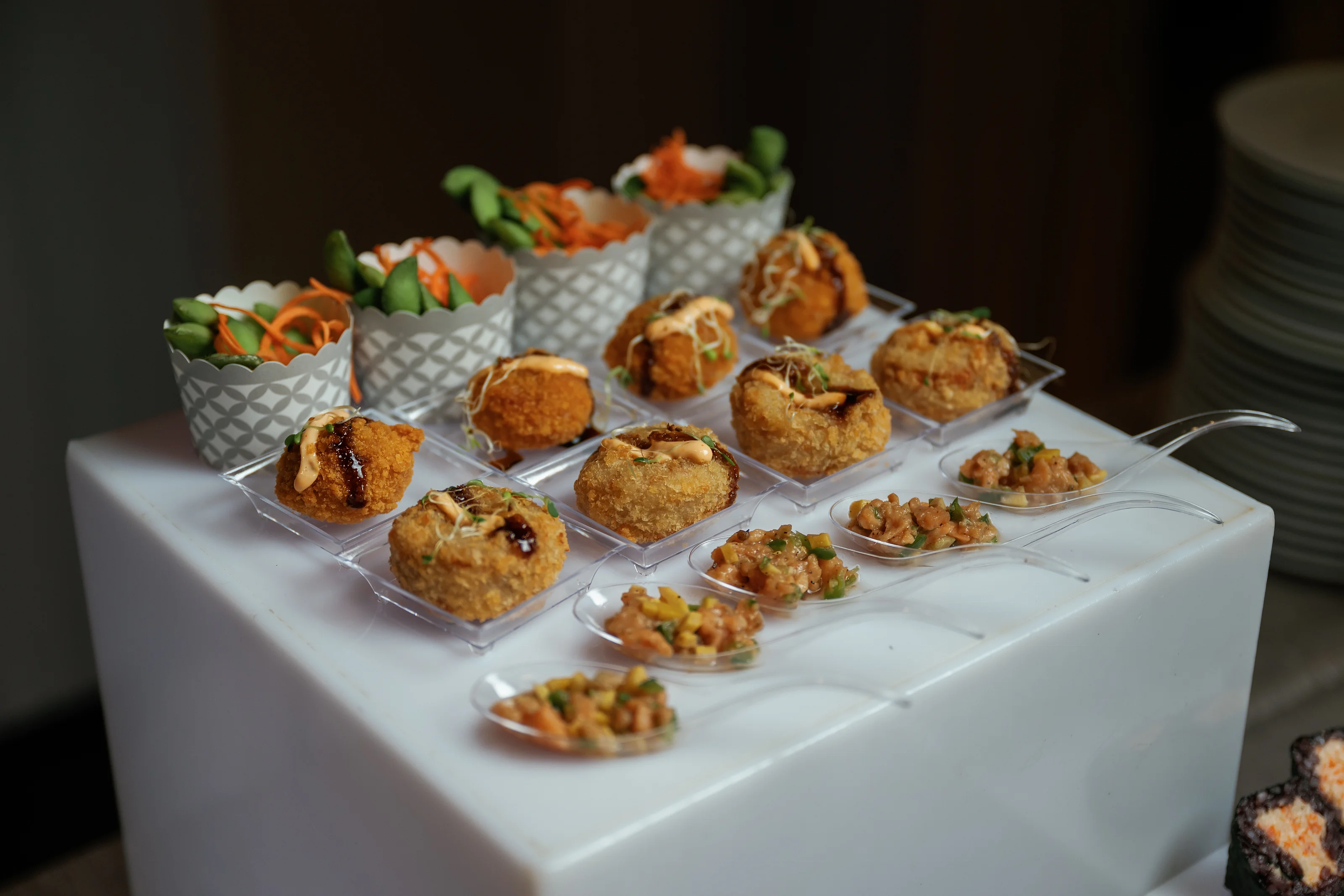 Assorted sushi rolls on a tiered catering display