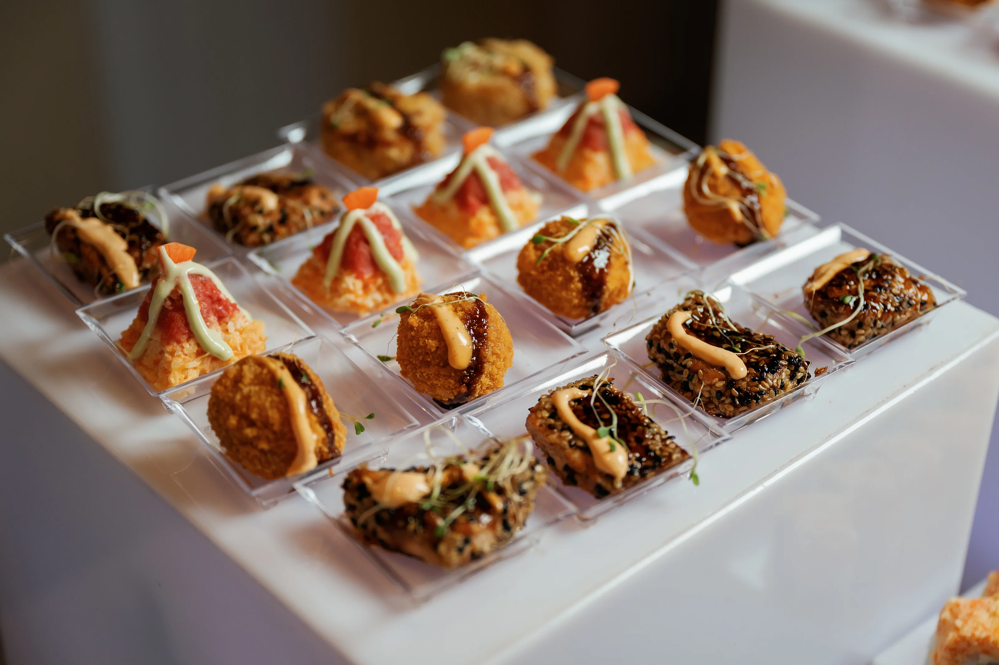 Sushi rolls served on white platters