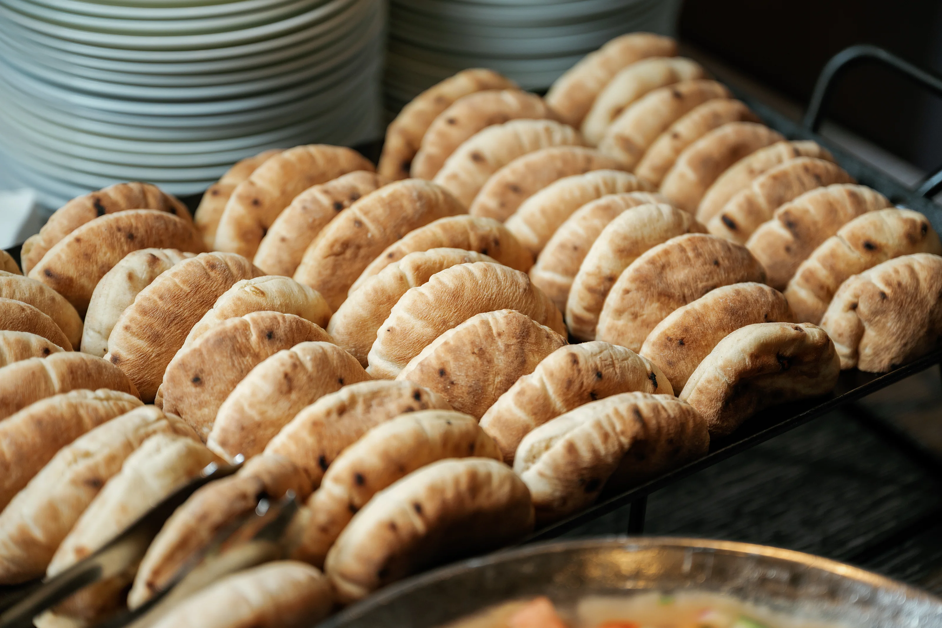 Rows of crescent-shaped pastries on a serving tray