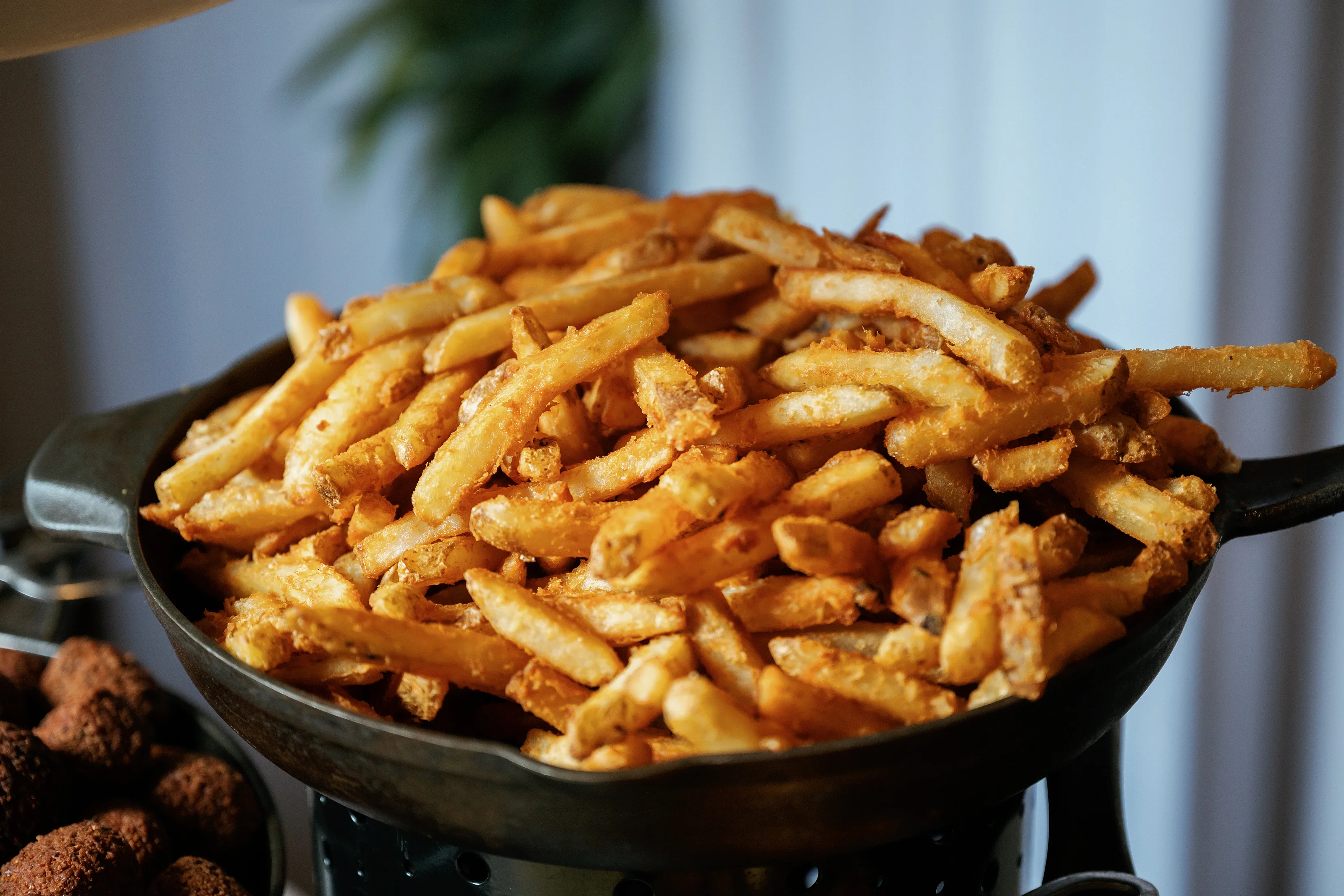 Golden fried appetizer strips in a serving bowl