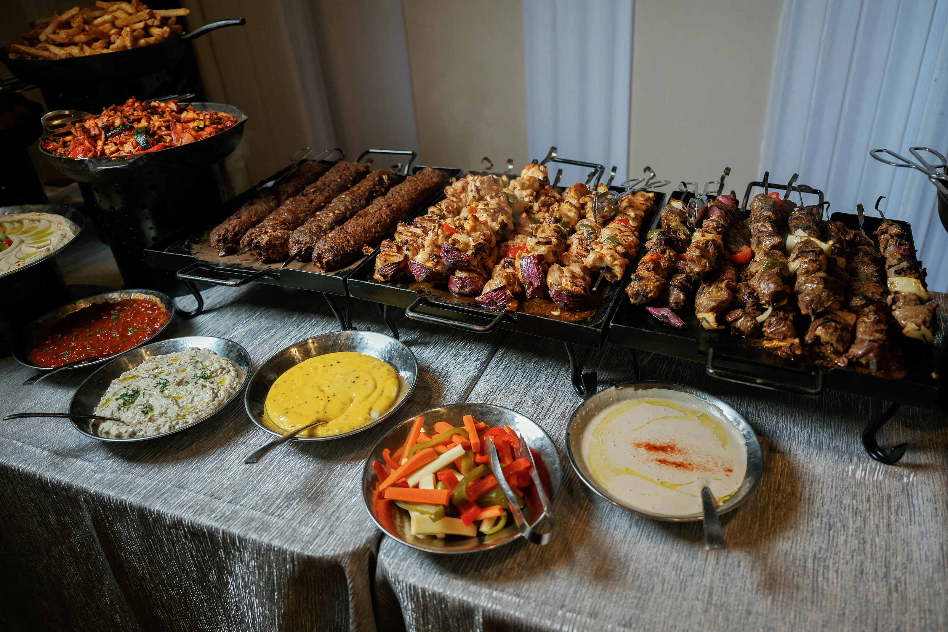 Grilled kebabs with sauces and garnishes