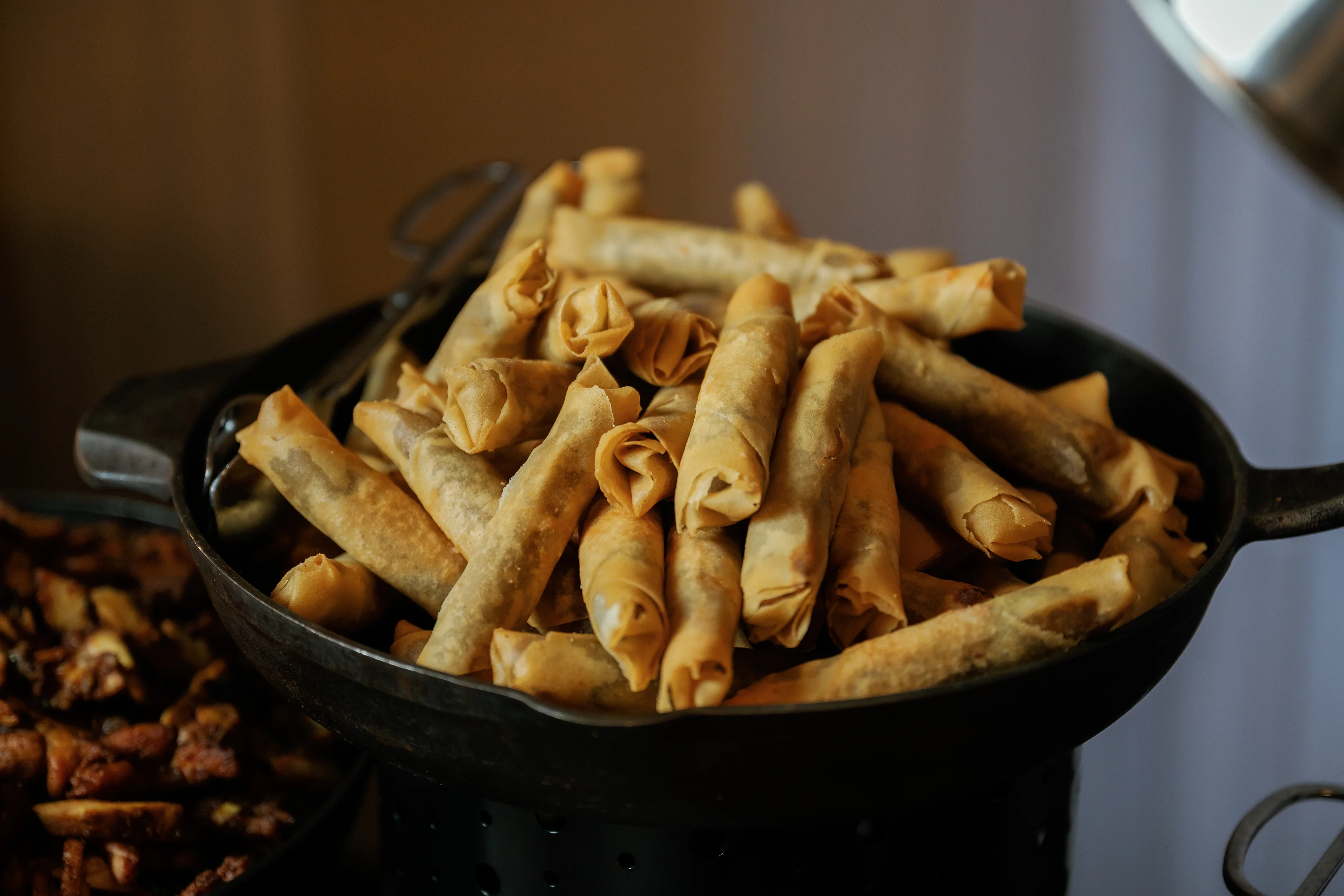 Golden appetizer rolls in a serving bowl