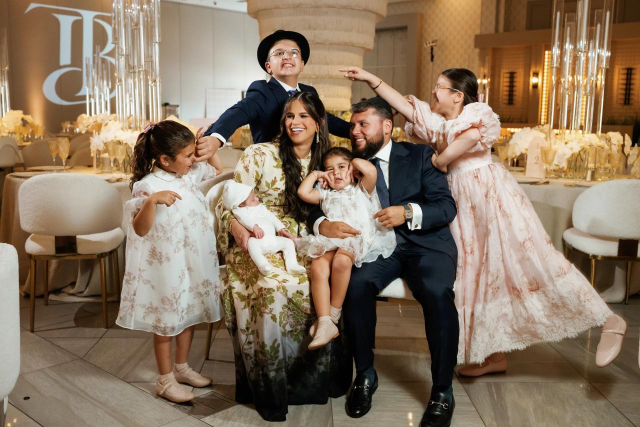 Adults and children share a playful moment in the decorated banquet hall