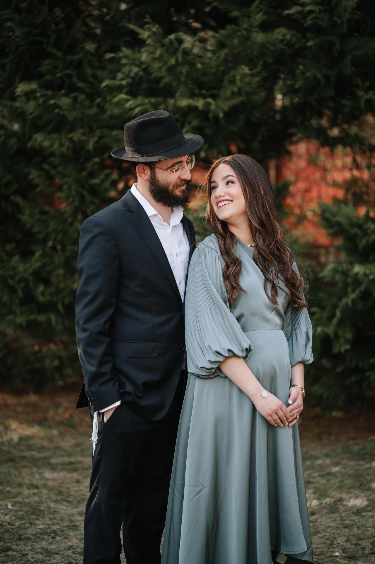 Couple smiling at each other during outdoor family portraits