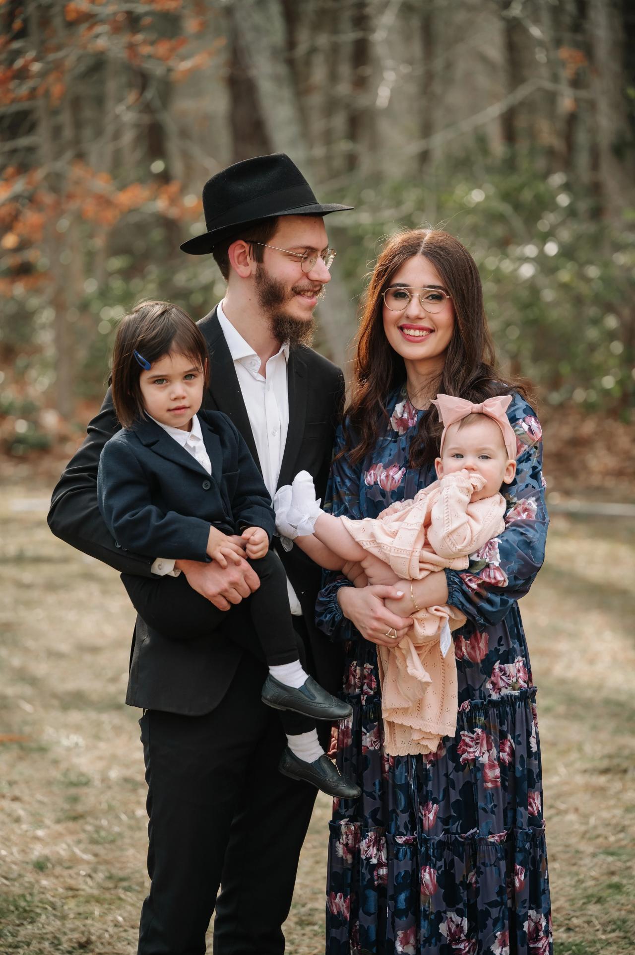 Family of four smiling together during Bat Mitzvah portraits