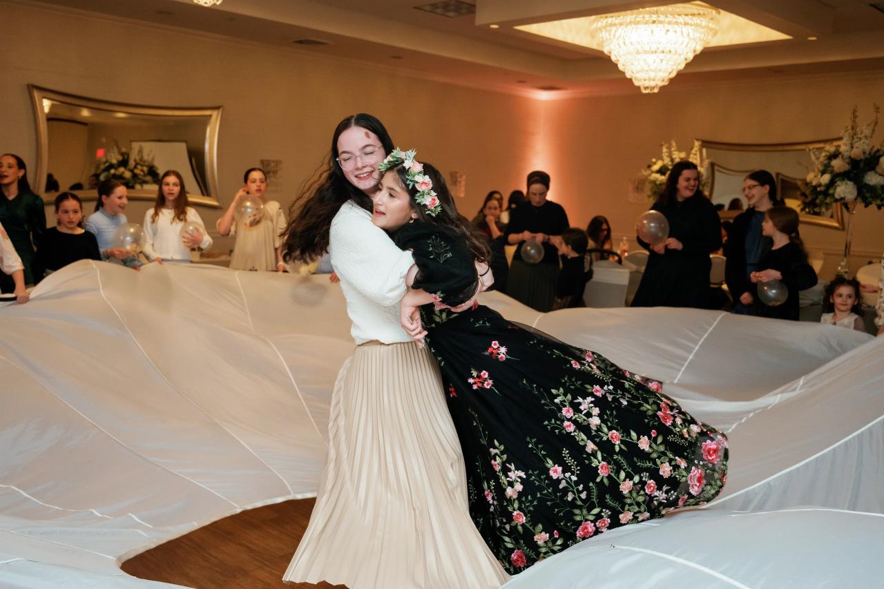 Girl hugging a guest on the dance floor