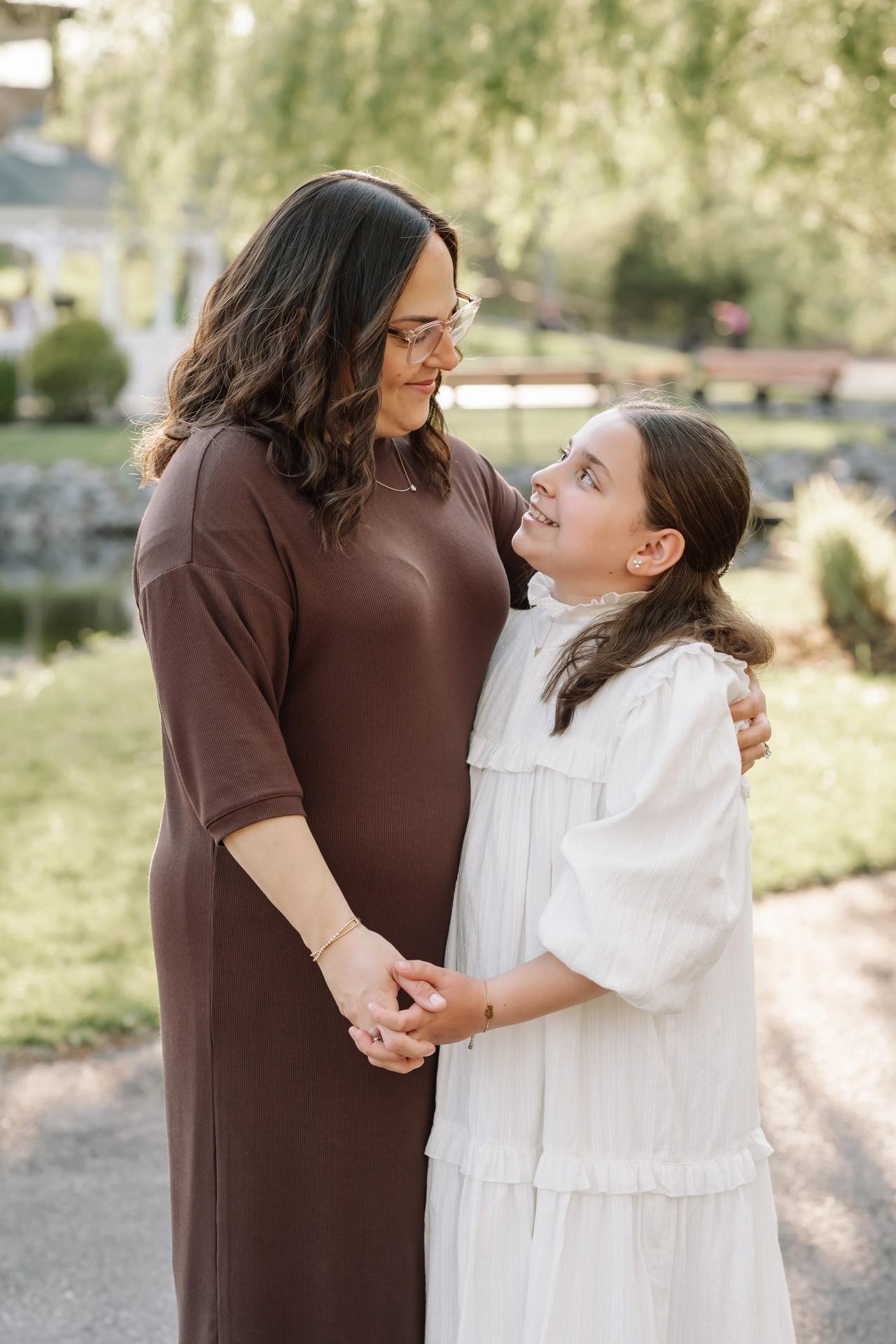 Mother and daughter looking at each other during outdoor family portraits