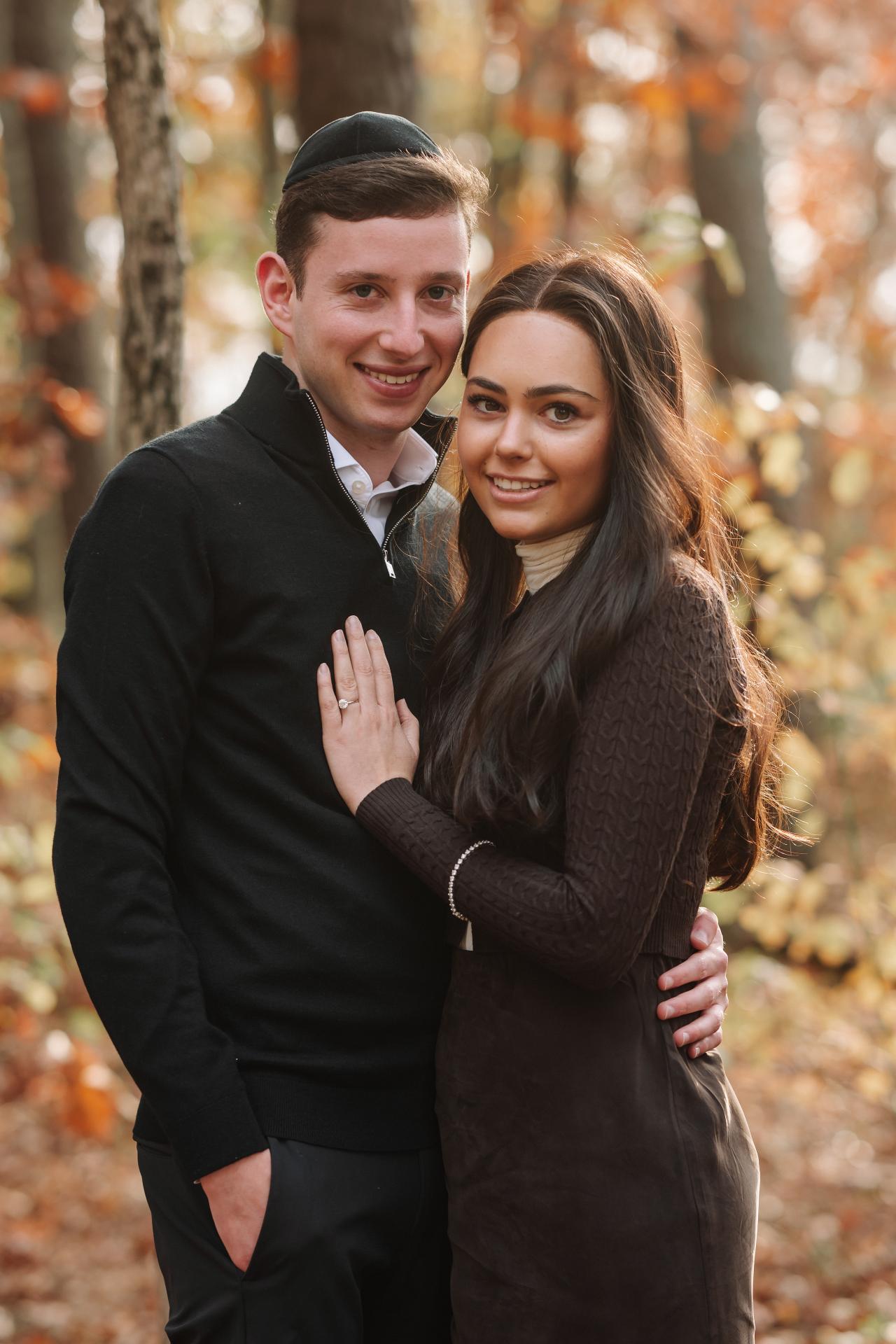Close portrait of a couple standing together in autumn woodland