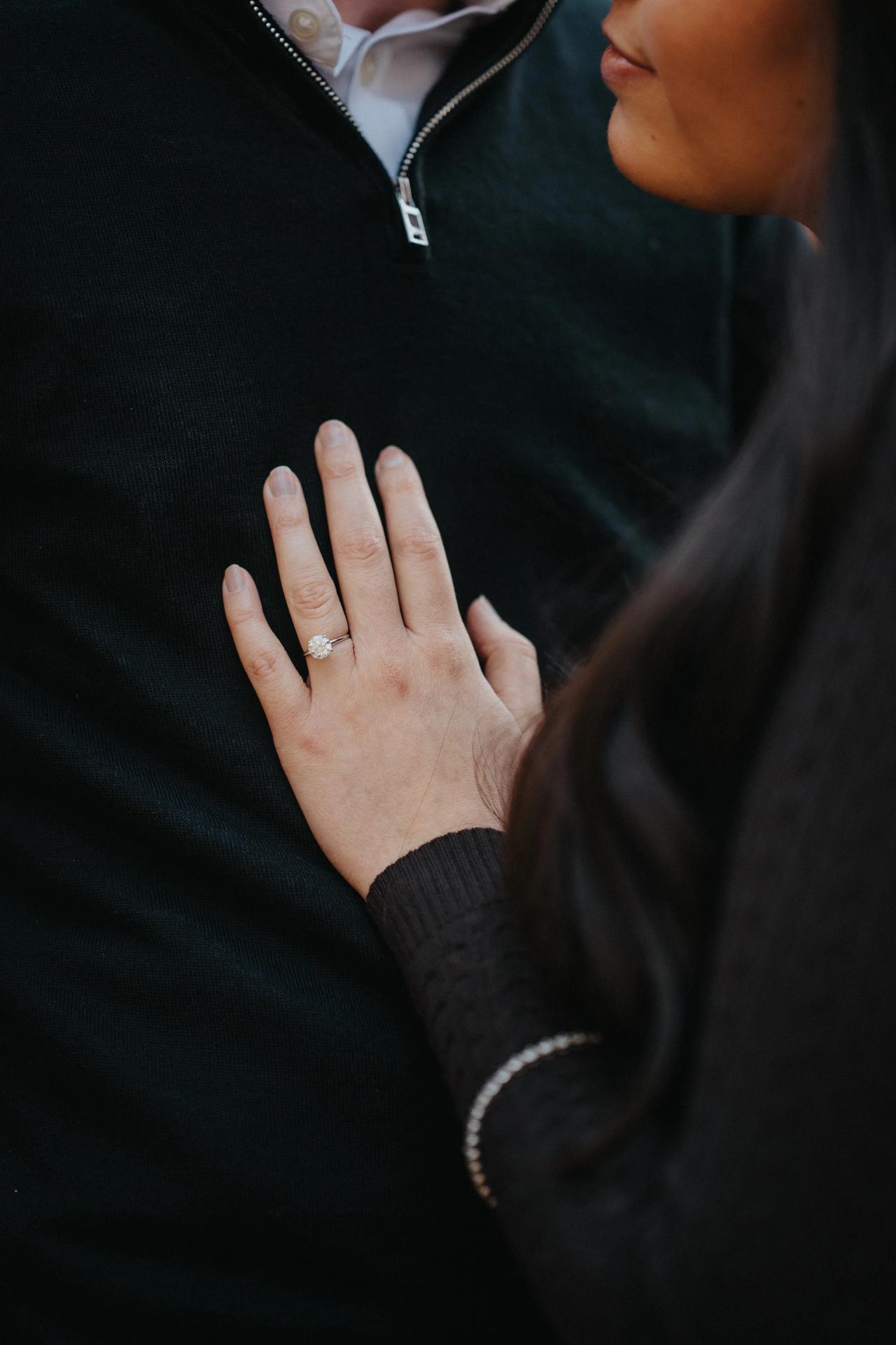 Detail of a couple holding each other during a woodland portrait session