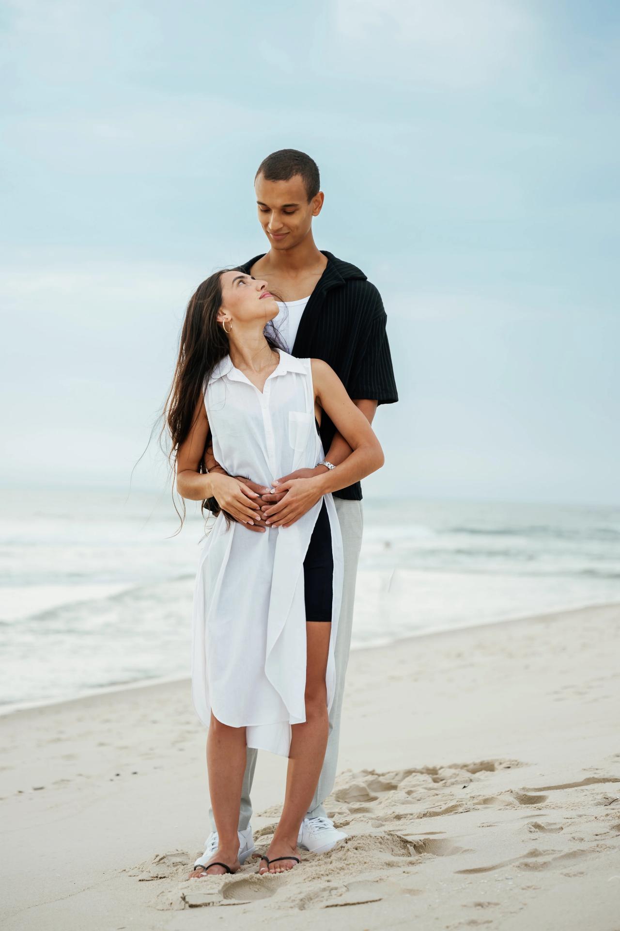 Couple embracing on the shoreline during a beach portrait session