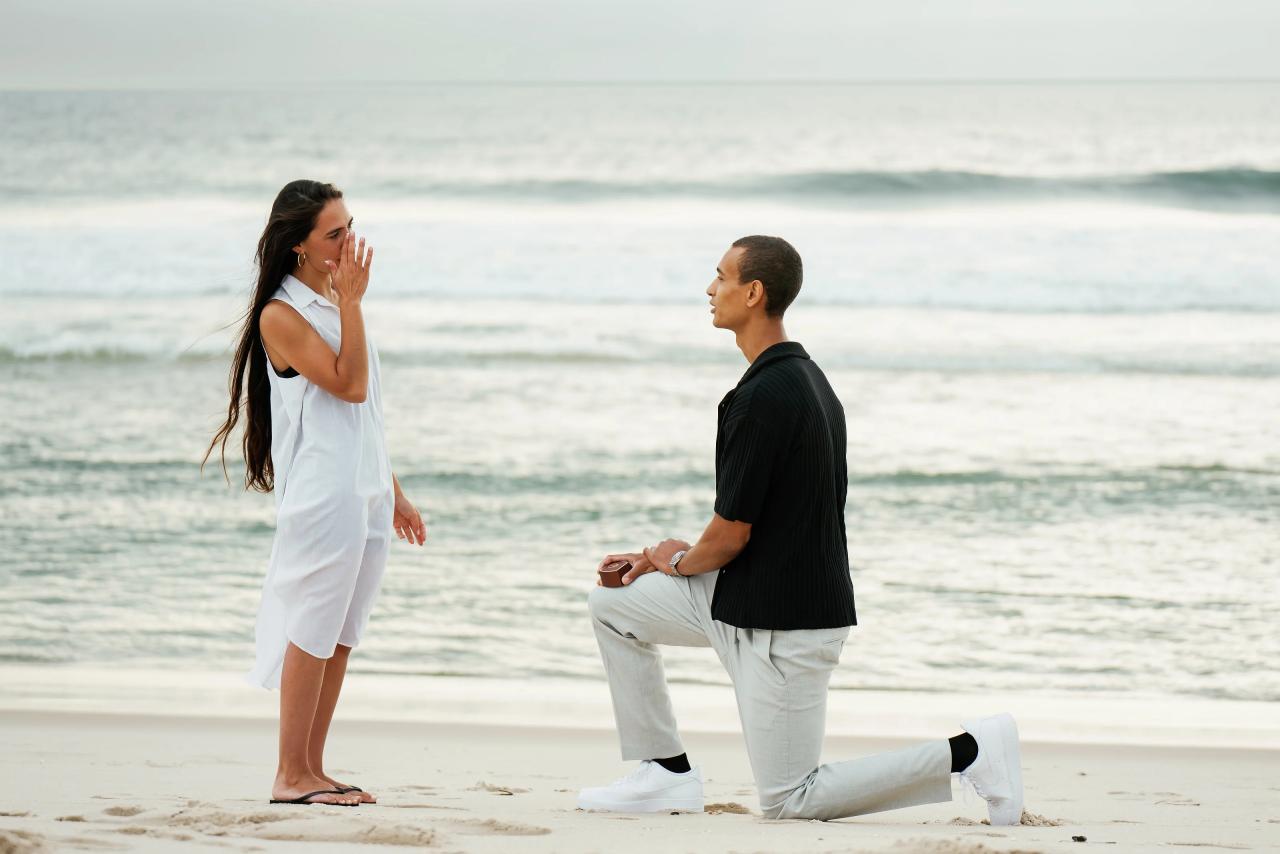 Woman reacting with surprise during a proposal on the beach