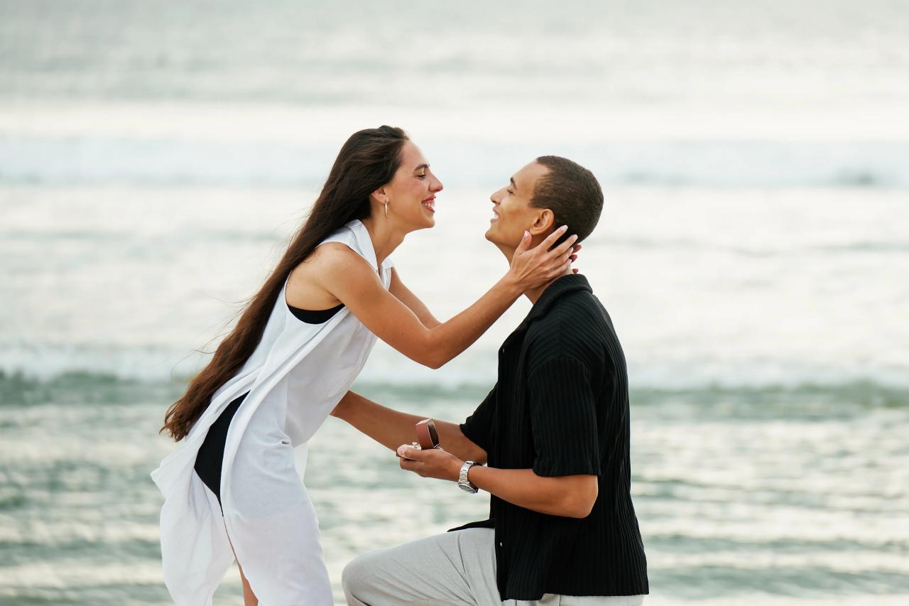 Couple leaning toward each other during the beach proposal
