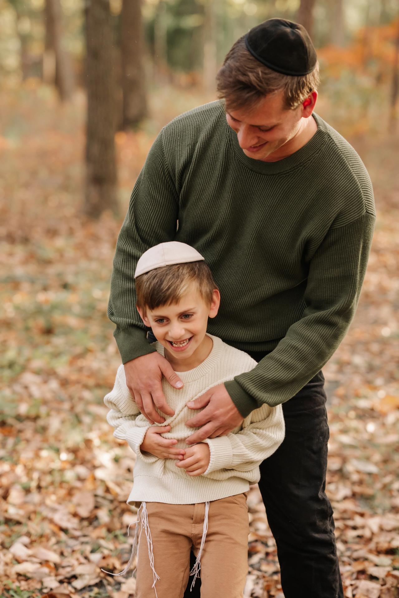 Father and son sharing a playful moment in the woods