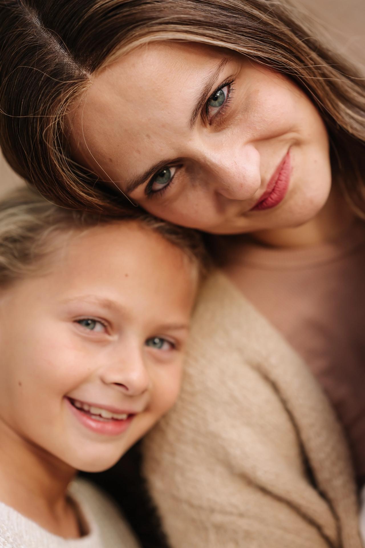 Mother and daughter sharing a close embrace outdoors