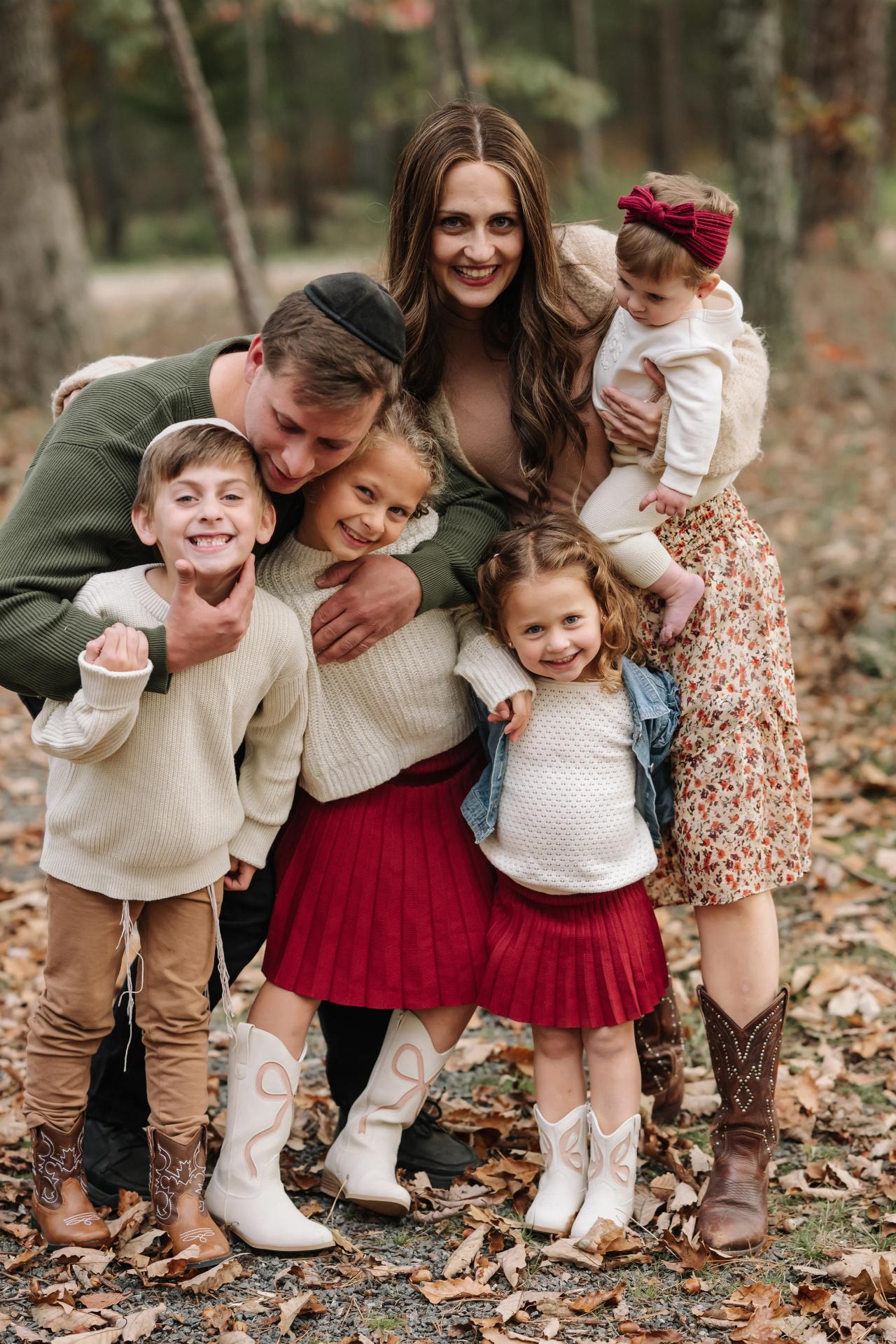 Parents cuddling their children during an outdoor family session