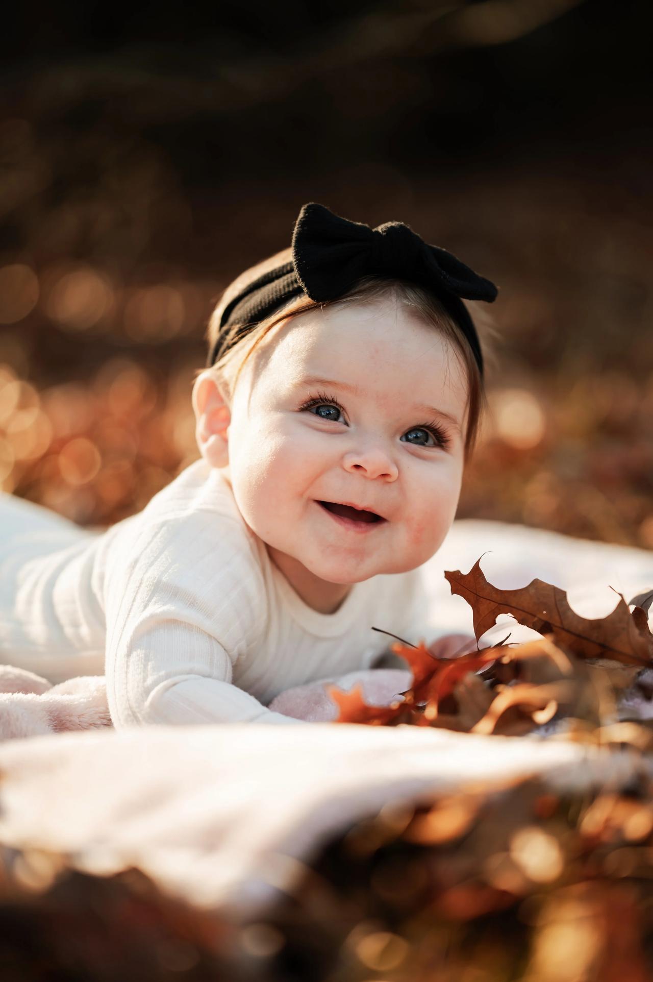 Close-up of a smiling baby during a fall family photoshoot