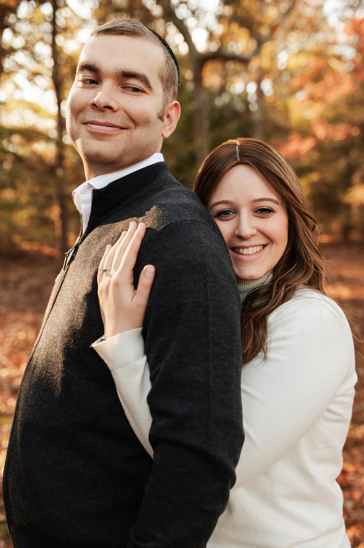 Mother embracing the father from behind during an autumn photoshoot