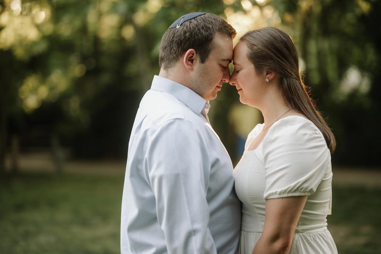 Close engagement portrait of a couple touching foreheads