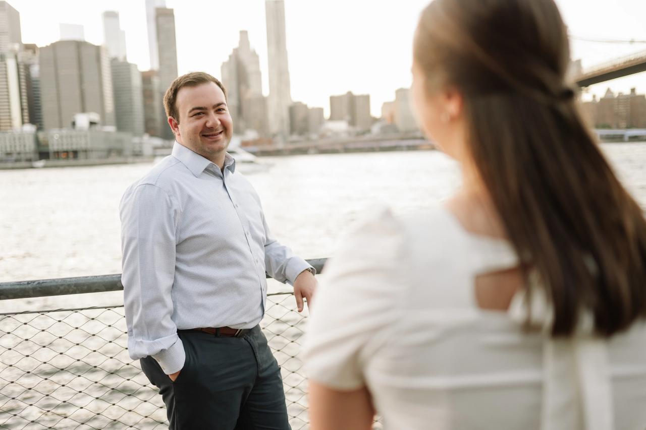 Man smiling at his partner with the city skyline behind him