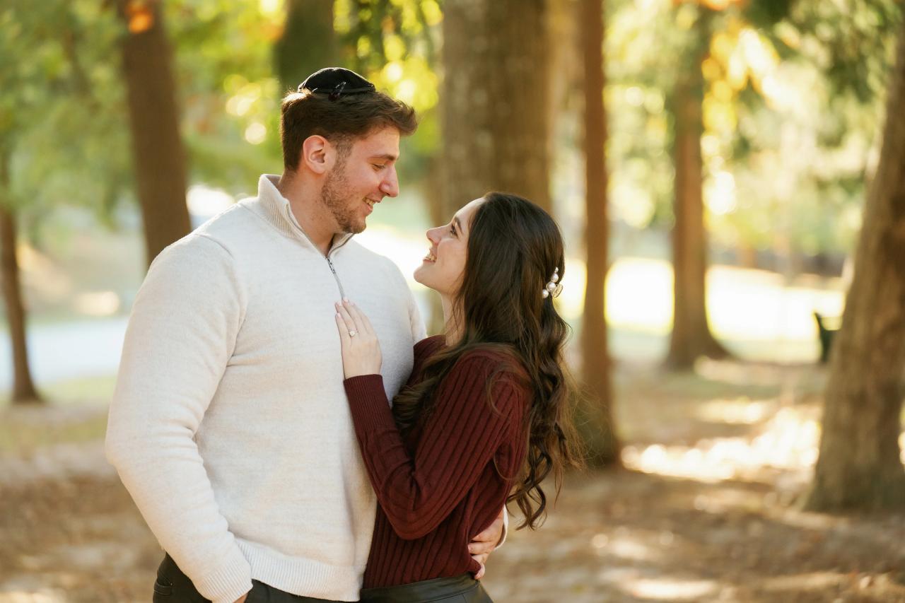 Couple smiling at each other during an autumn engagement shoot
