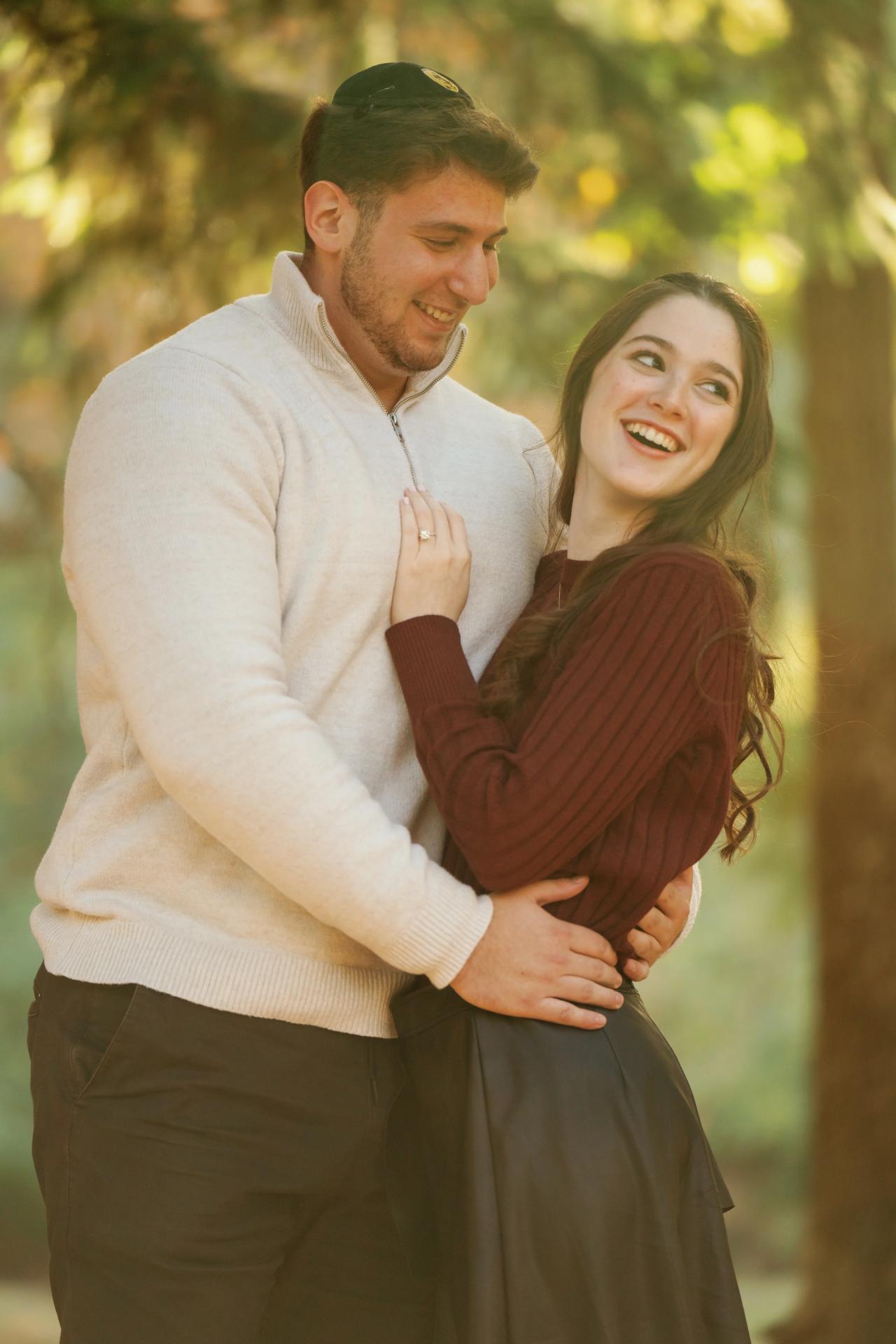 Couple laughing together in warm autumn sunlight