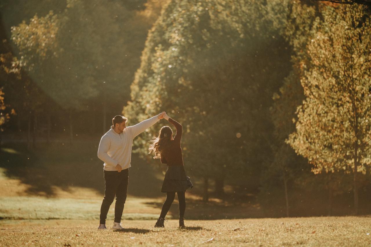 Couple twirling together during their outdoor engagement session
