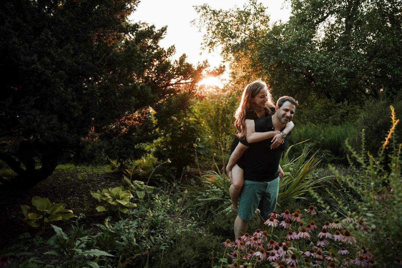 Couple sharing a playful piggyback moment during their engagement shoot