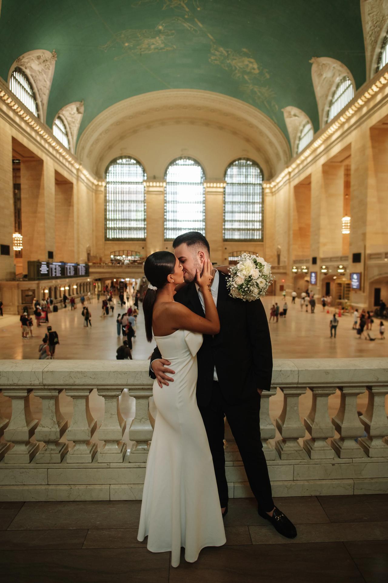 Full-length engagement portrait of a couple on the balcony at Grand Central Terminal