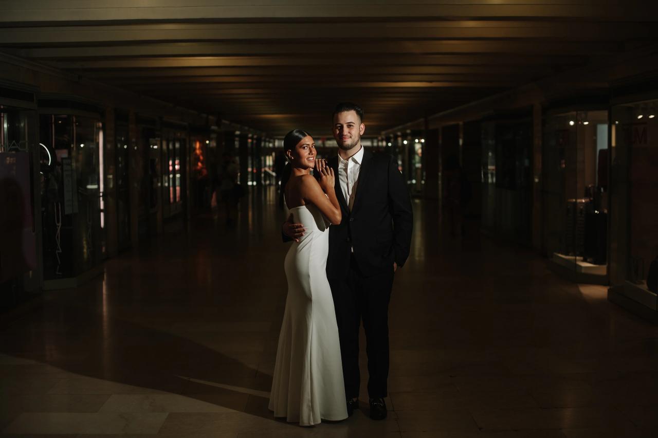 Couple standing together in a softly lit terminal passageway