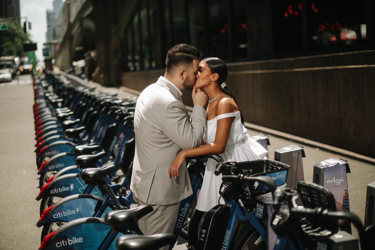 Couple sharing a kiss beside a bicycle station in New York City