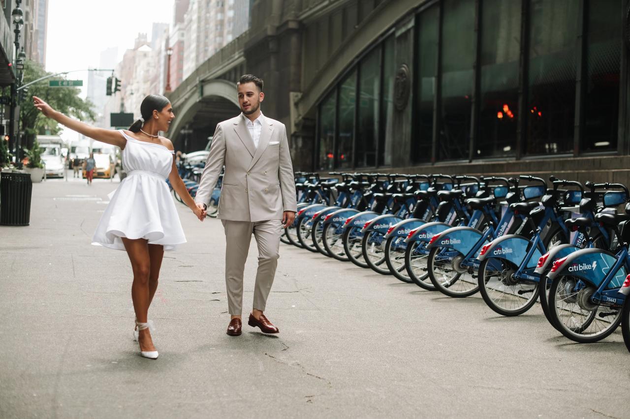 Woman twirling beside her partner during a city engagement session