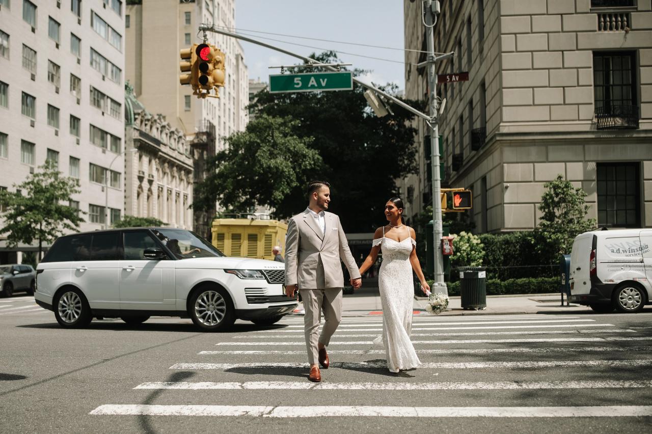 Couple holding hands while crossing a New York City street