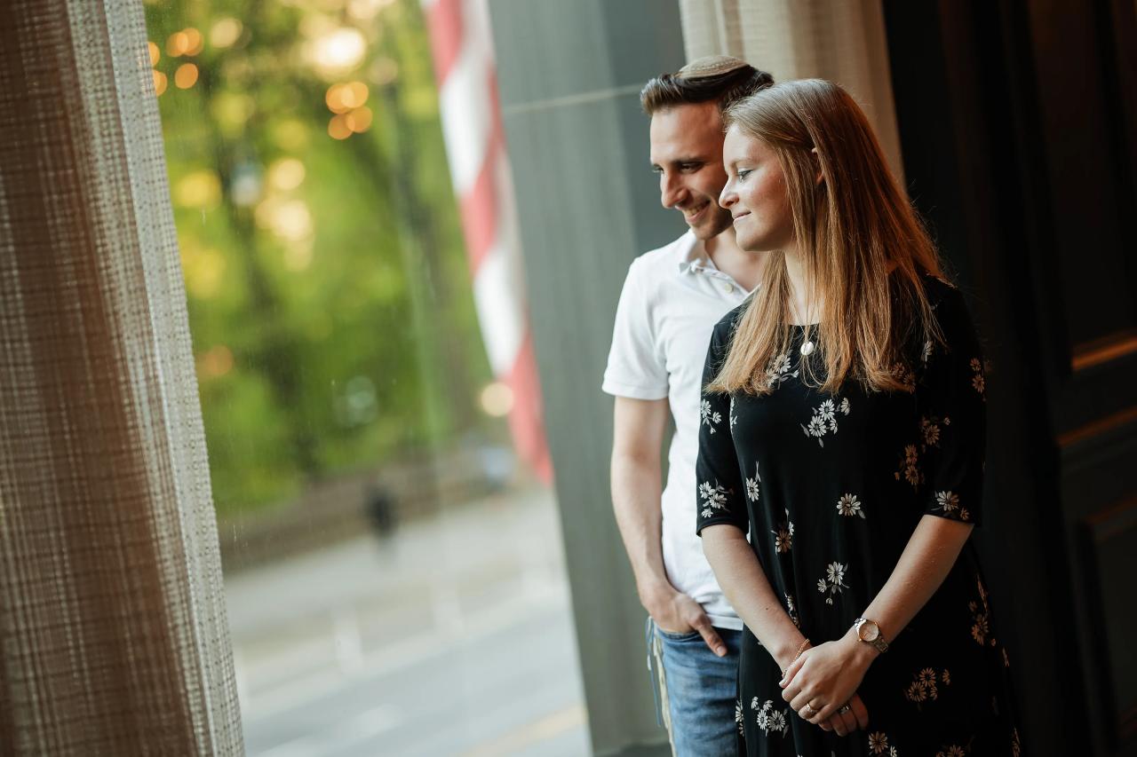 Couple looking outdoors beside a window