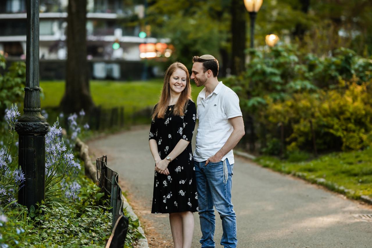 Couple smiling beside a flowering park path