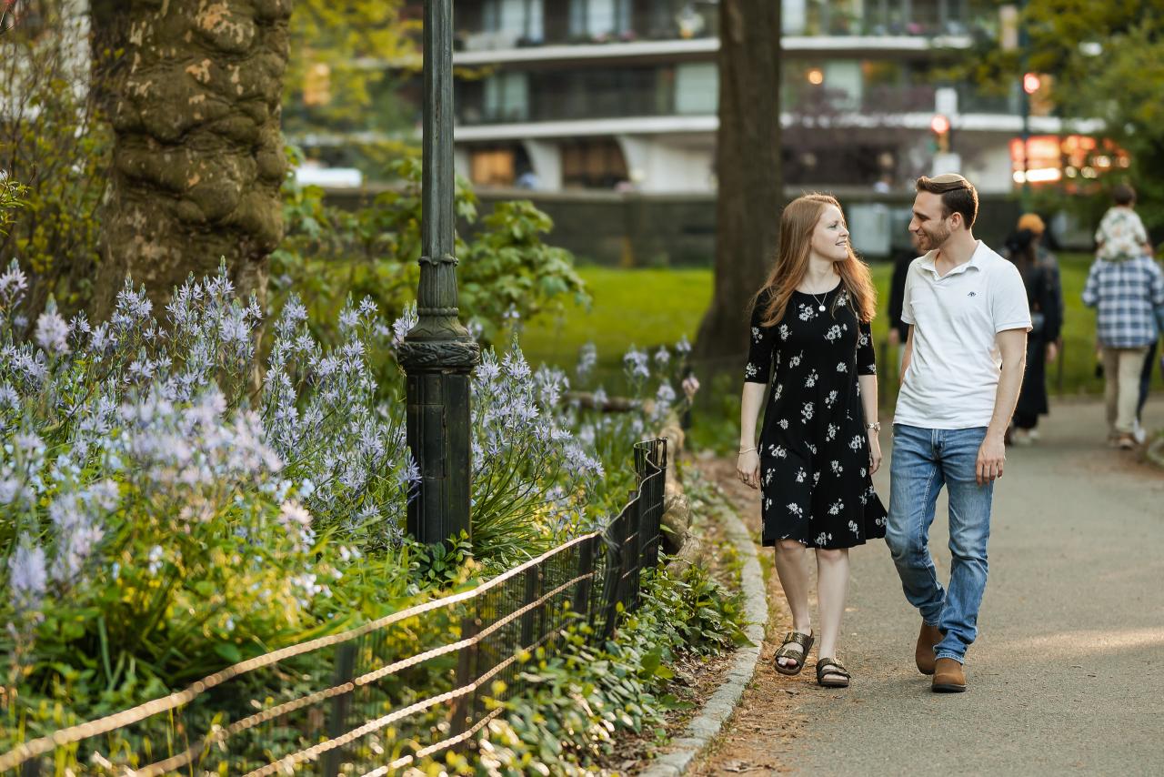 Couple walking beside spring flowers
