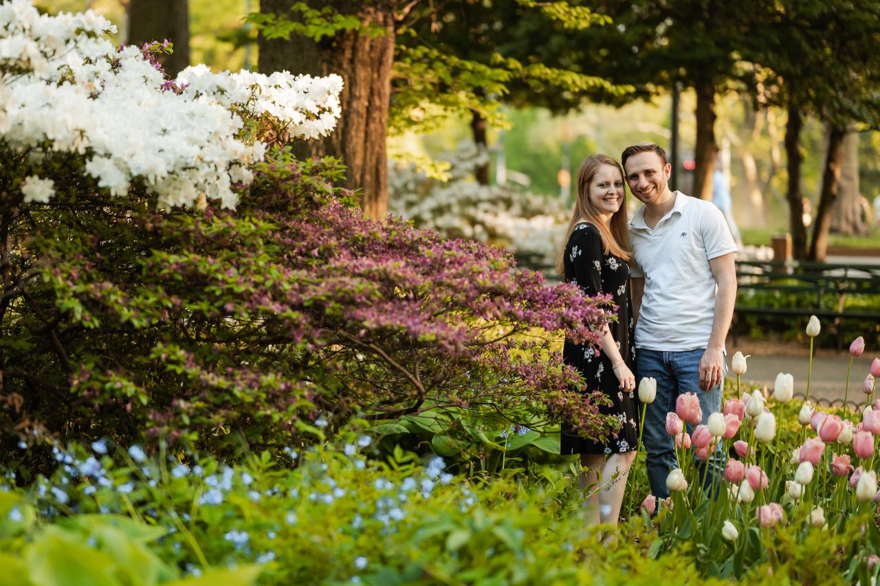 Couple surrounded by flowering shrubs and tulips