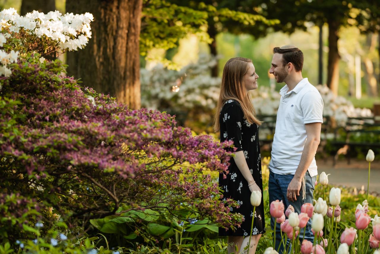 Couple facing each other in a spring garden