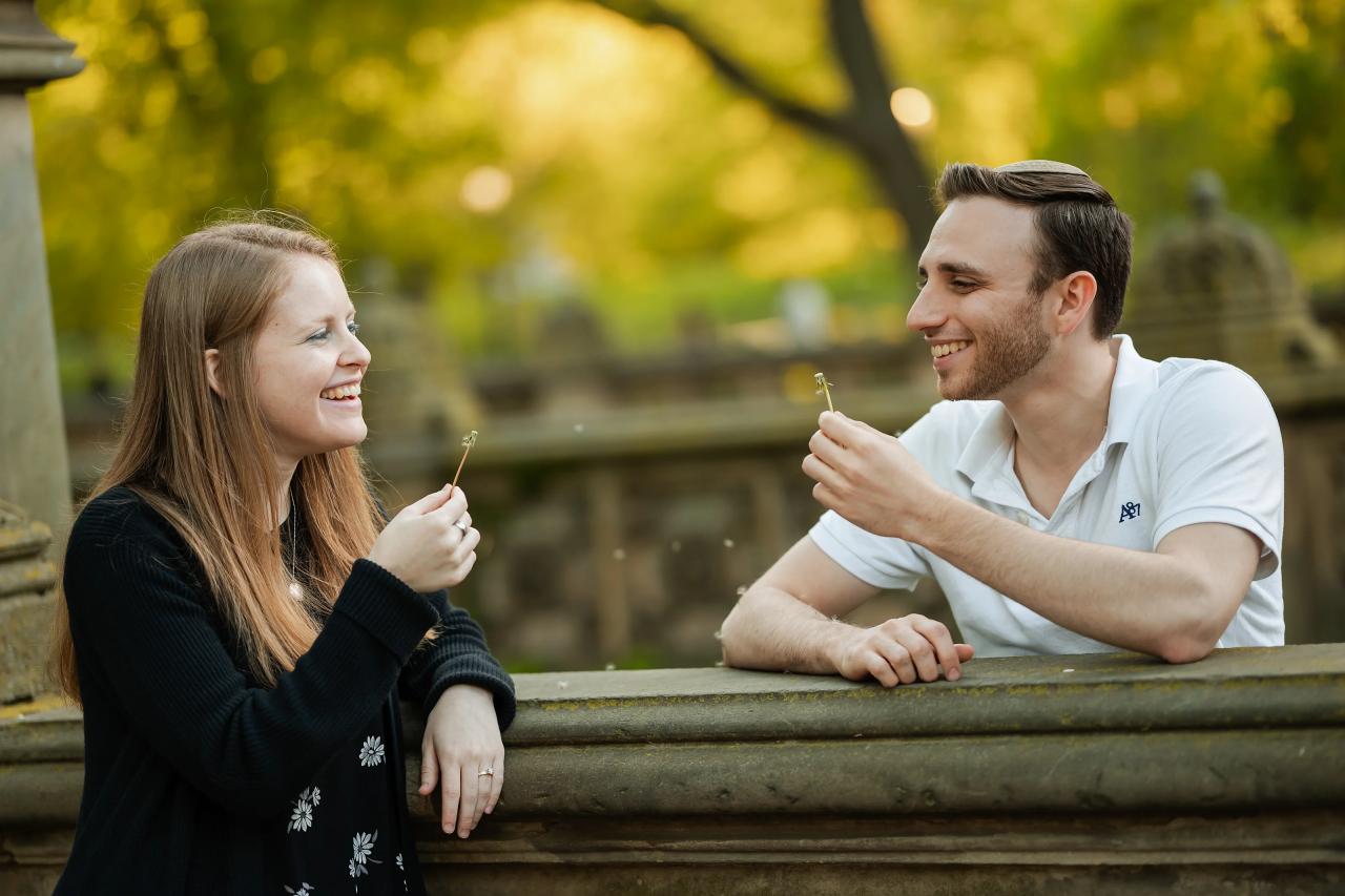 Couple laughing together at a carved stone balustrade