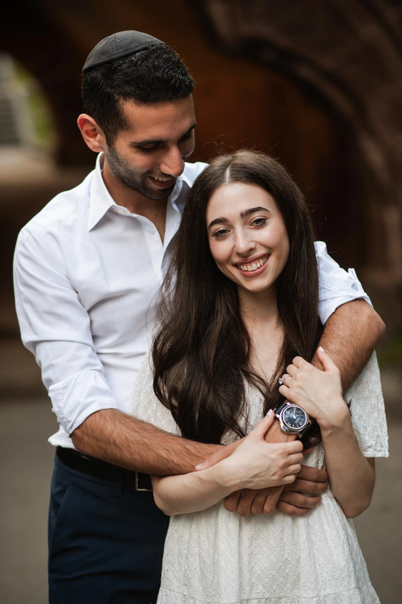 Close engagement portrait of a couple embracing