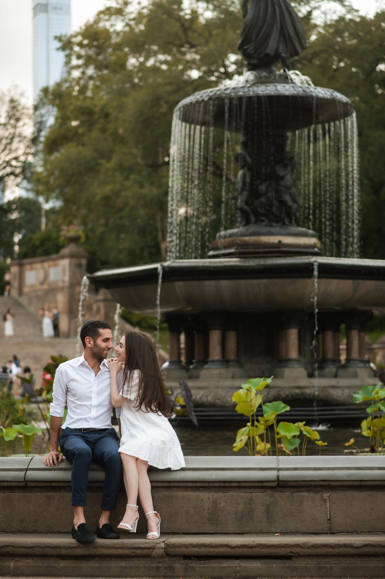 Couple seated beside a fountain in Central Park